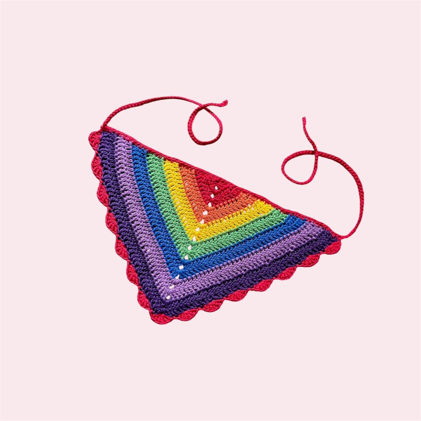Crochet bandana in rainbow stripes on a pink background