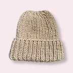 Beige knit beanie on plain background