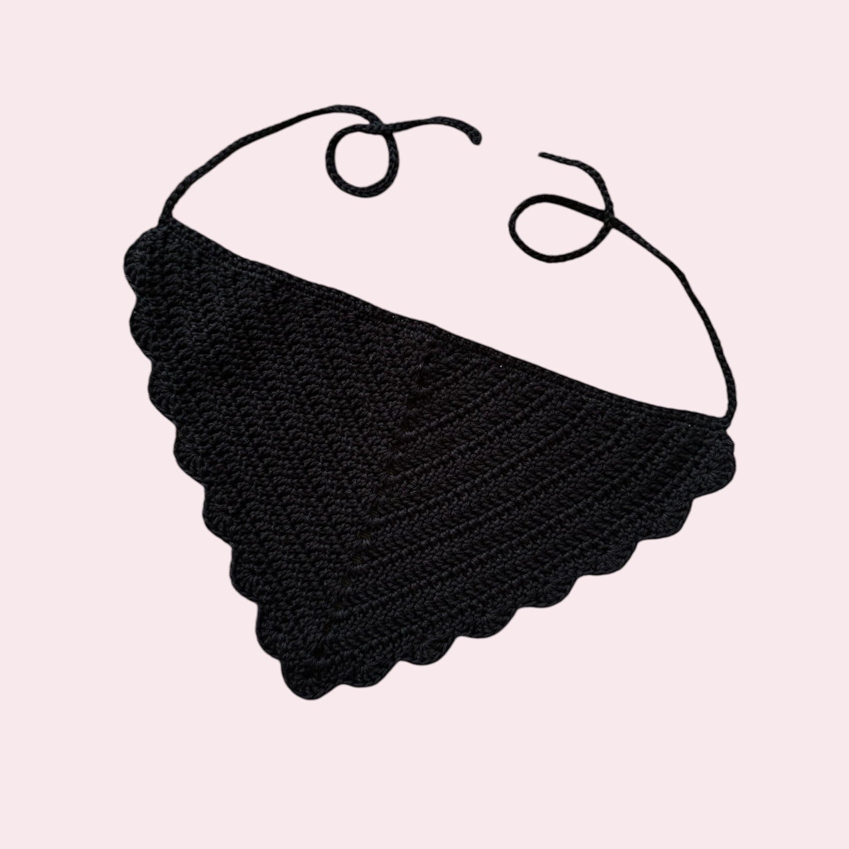 Black crochet bandana on pink background