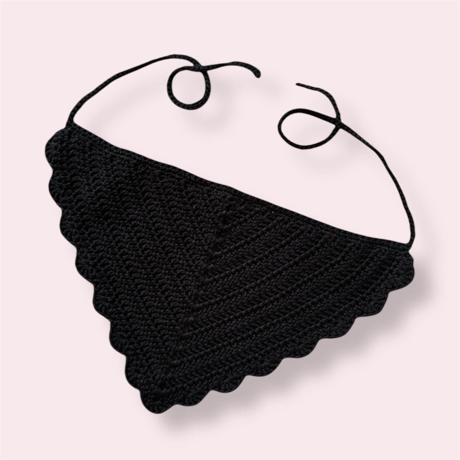 Black crocheted bandana on plain background