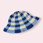 Blue and white gingham crochet bucket hat on plain background