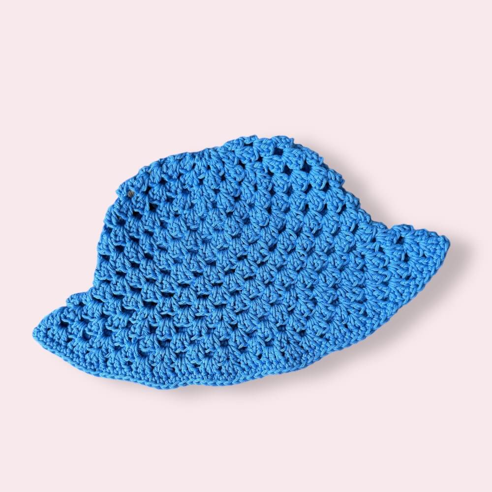 Blue crochet bucket hat on plain background
