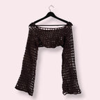 Brown crochet mesh sleeves on clothes hanger on plain background