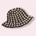 Brown striped crochet bucket hat on plain background