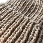 Close up texture of beige knit hat