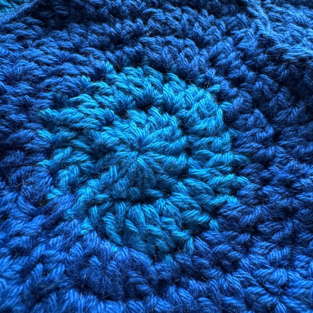 Close up texture of blue crochet coaster