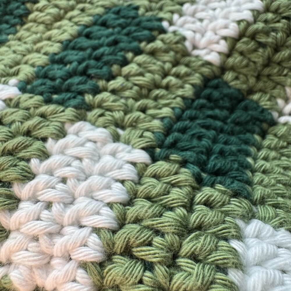 Close up texture of green crochet gingham bucket hat