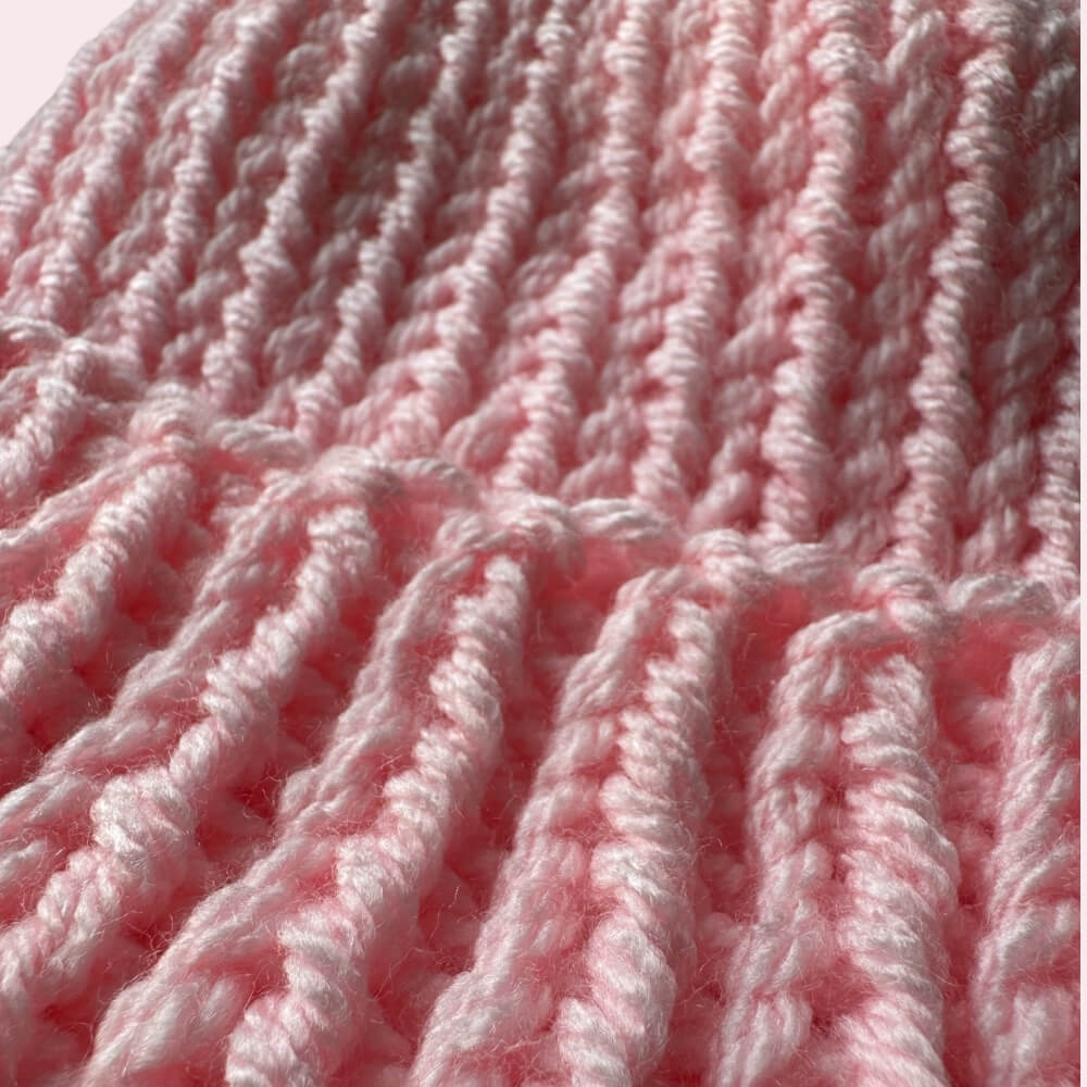 Close up texture of light pink knit hat