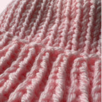 Close up texture of light pink knit hat