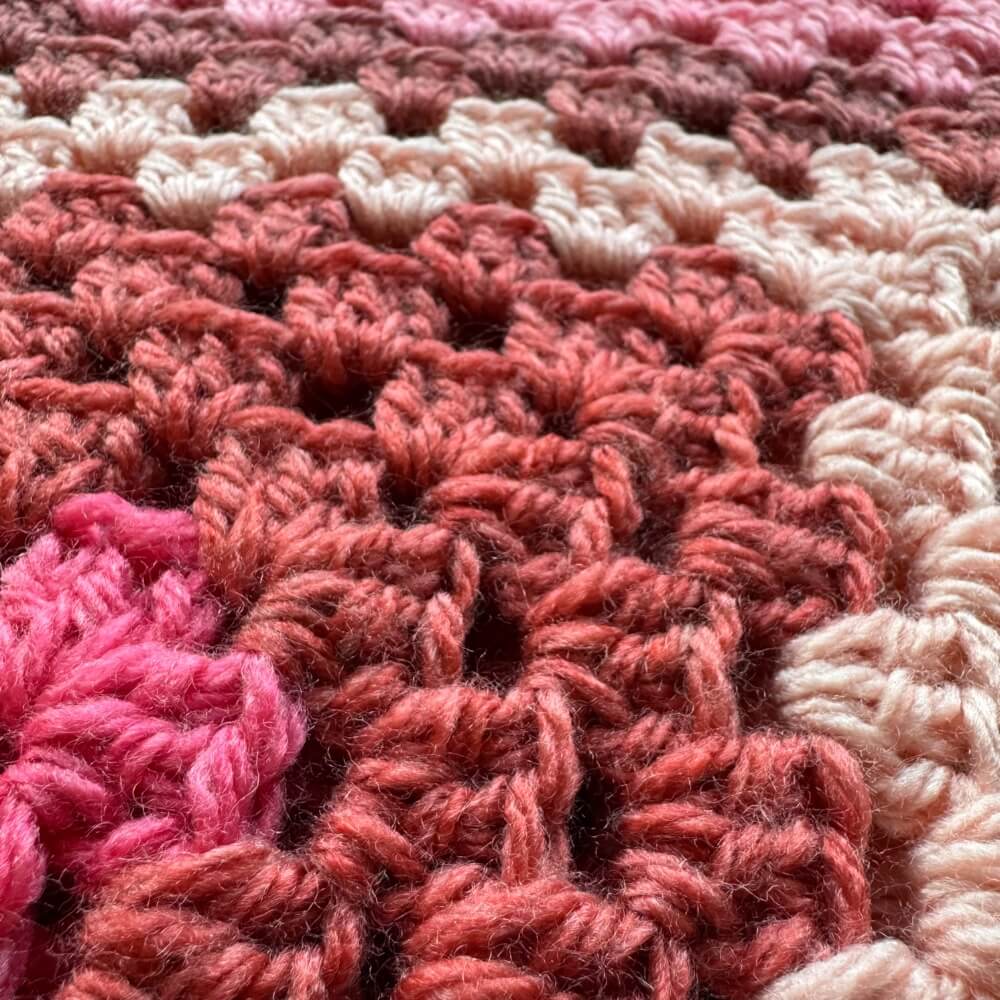 Close up texture of pink crochet cardigan