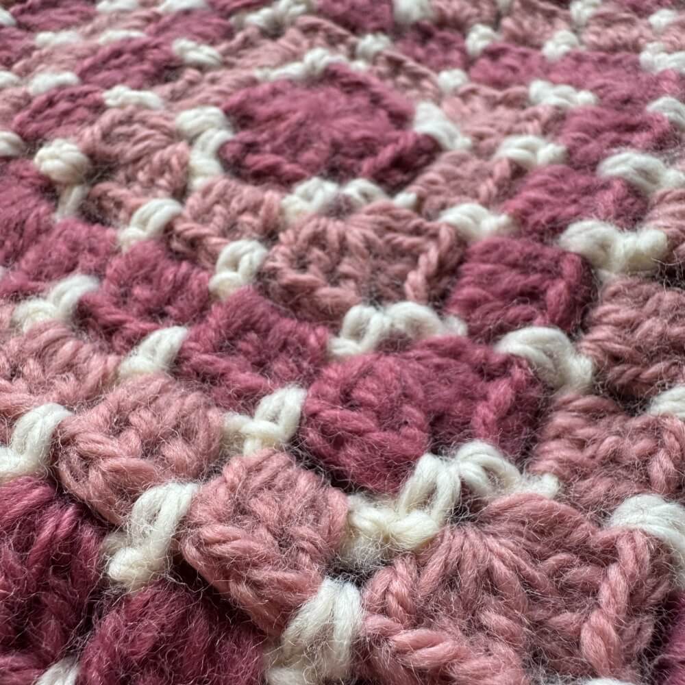 Close up texture of pink crochet scoodie hooded scarf