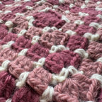 Close up texture of pink crochet scoodie hooded scarf