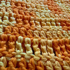 Close up texture shot of crochet yellow tee