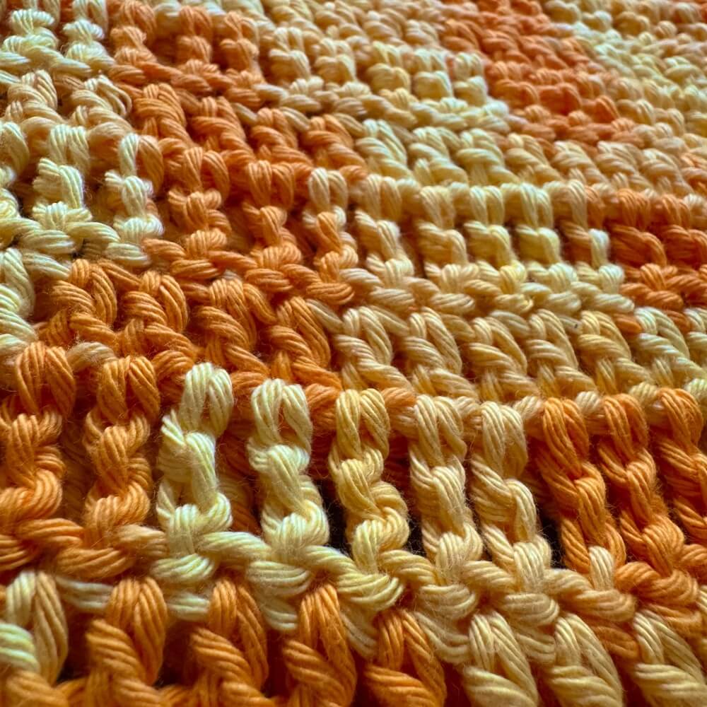 Close up texture shot of crochet yellow tee