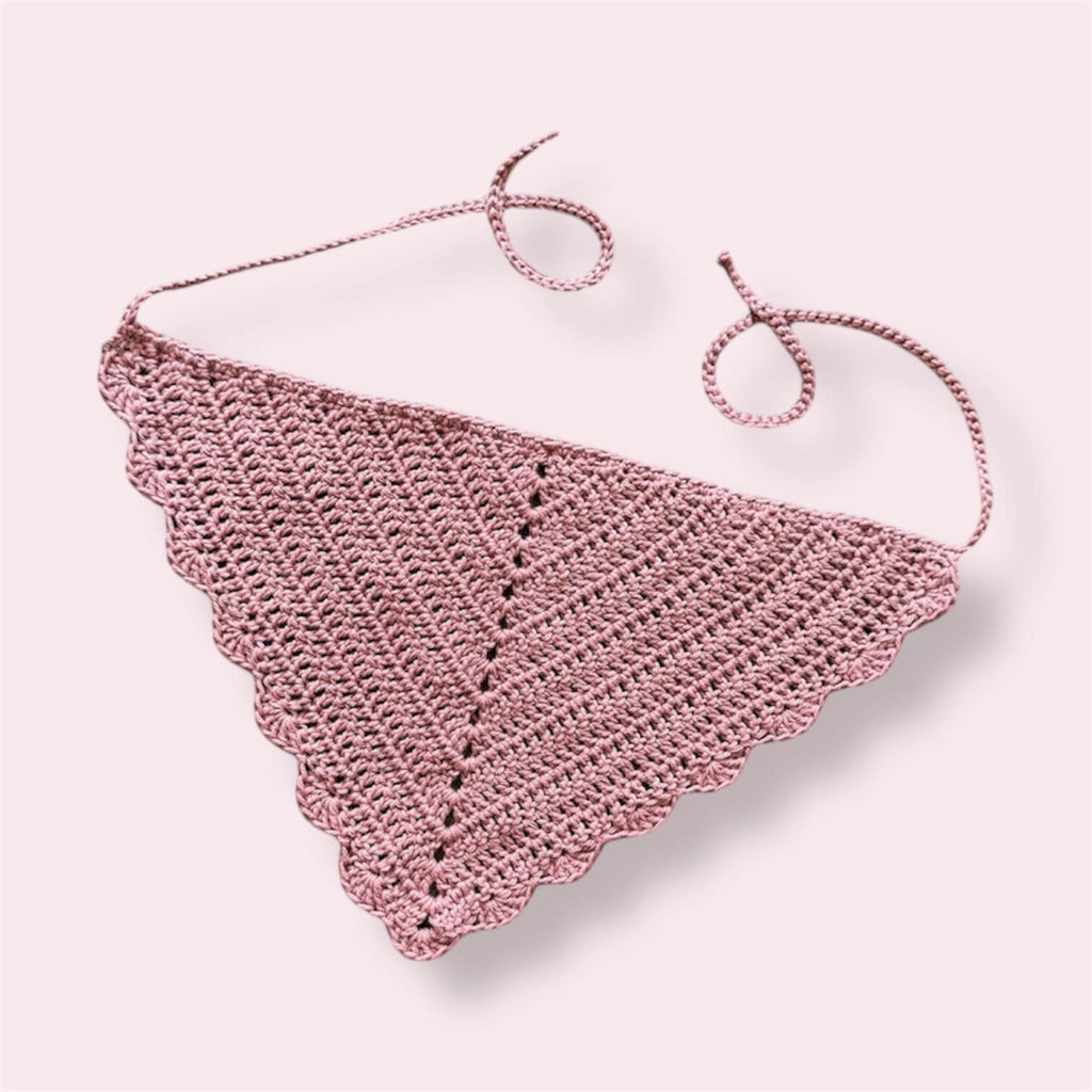 Crochet bandana in a dusty pink color on plain background