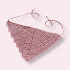 Crochet bandana in a dusty pink color on plain background