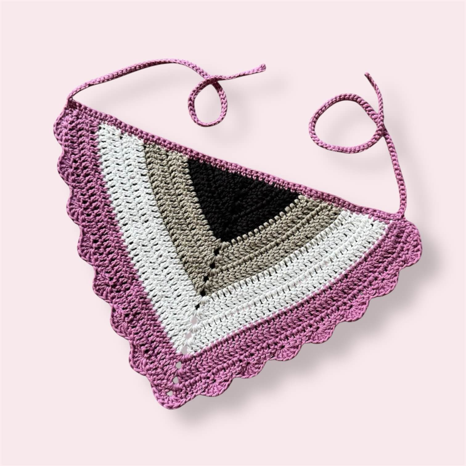 Crochet bandana in ace pride colors on plain background