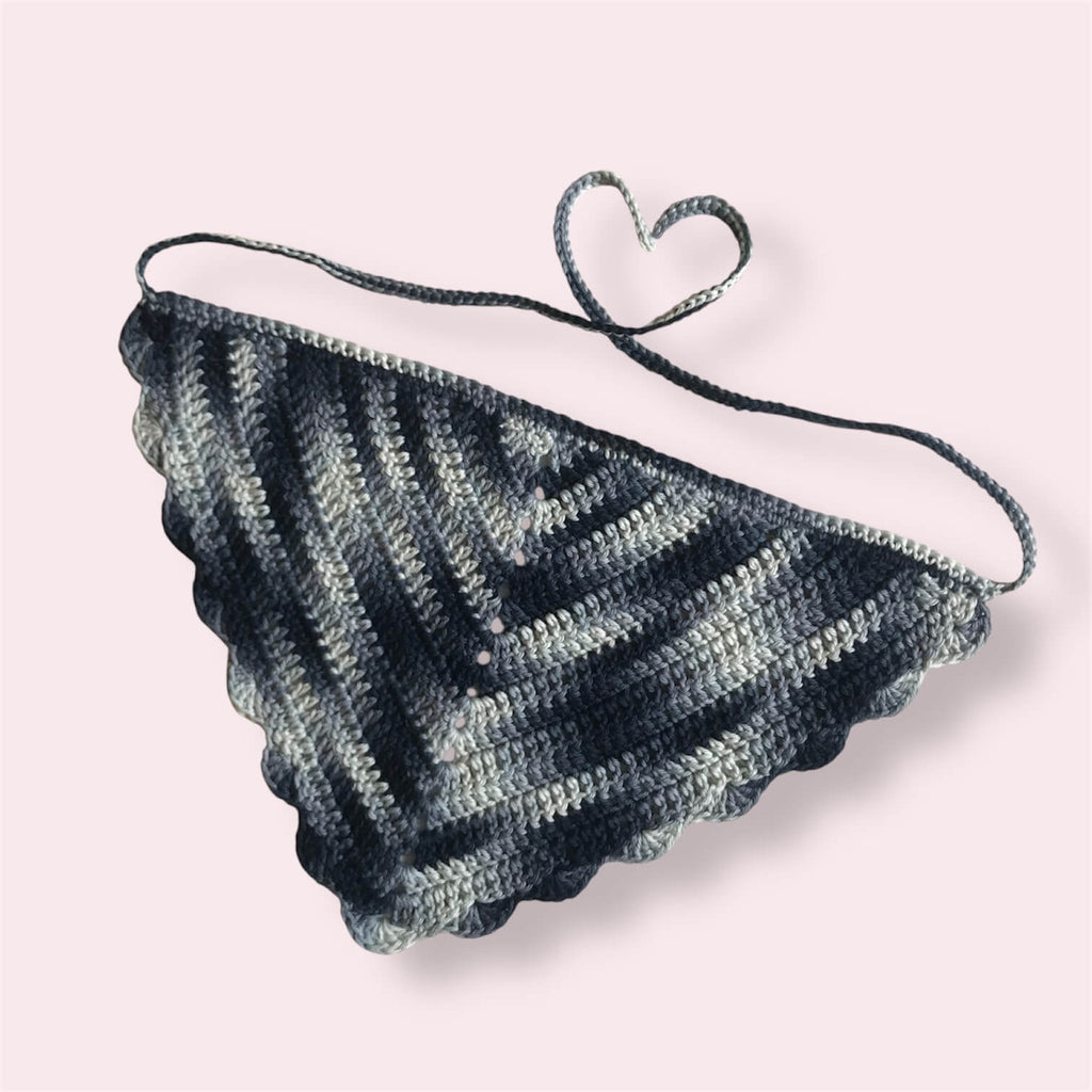 Crochet bandana in blue colors on plain background