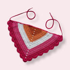 Crochet bandana in lesbian pride colors on plain background