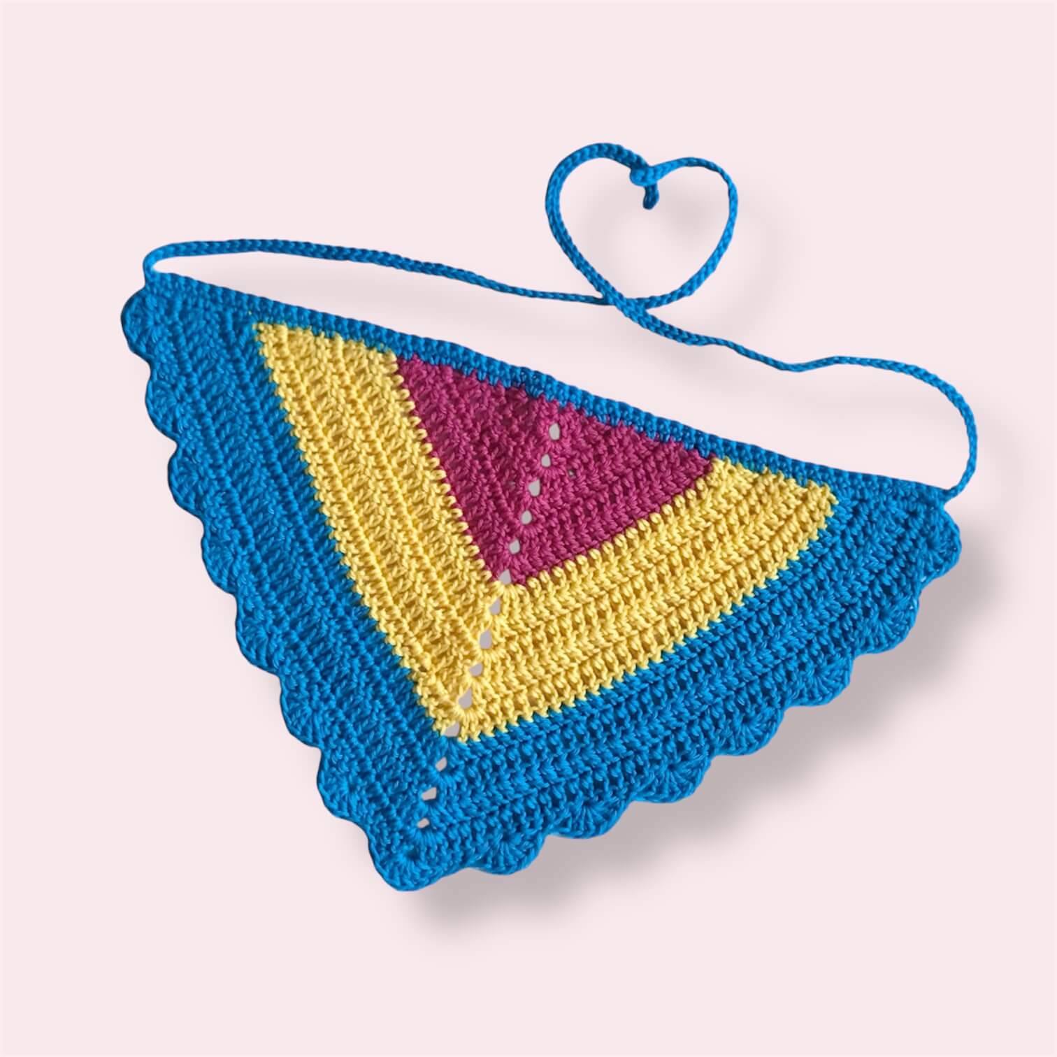 Crochet bandana in pan pride colors on plain background