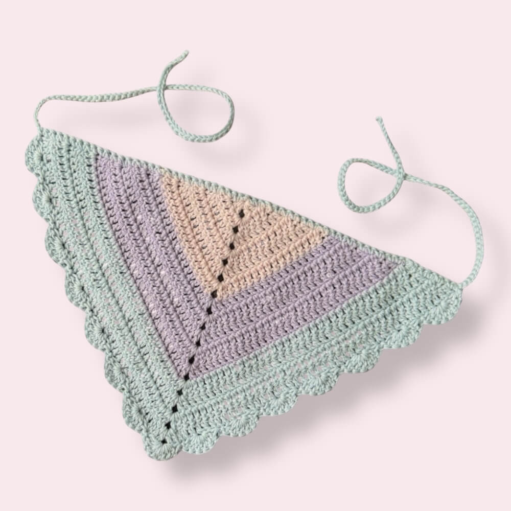 Crochet bandana in pastel bi pride colors on plain background