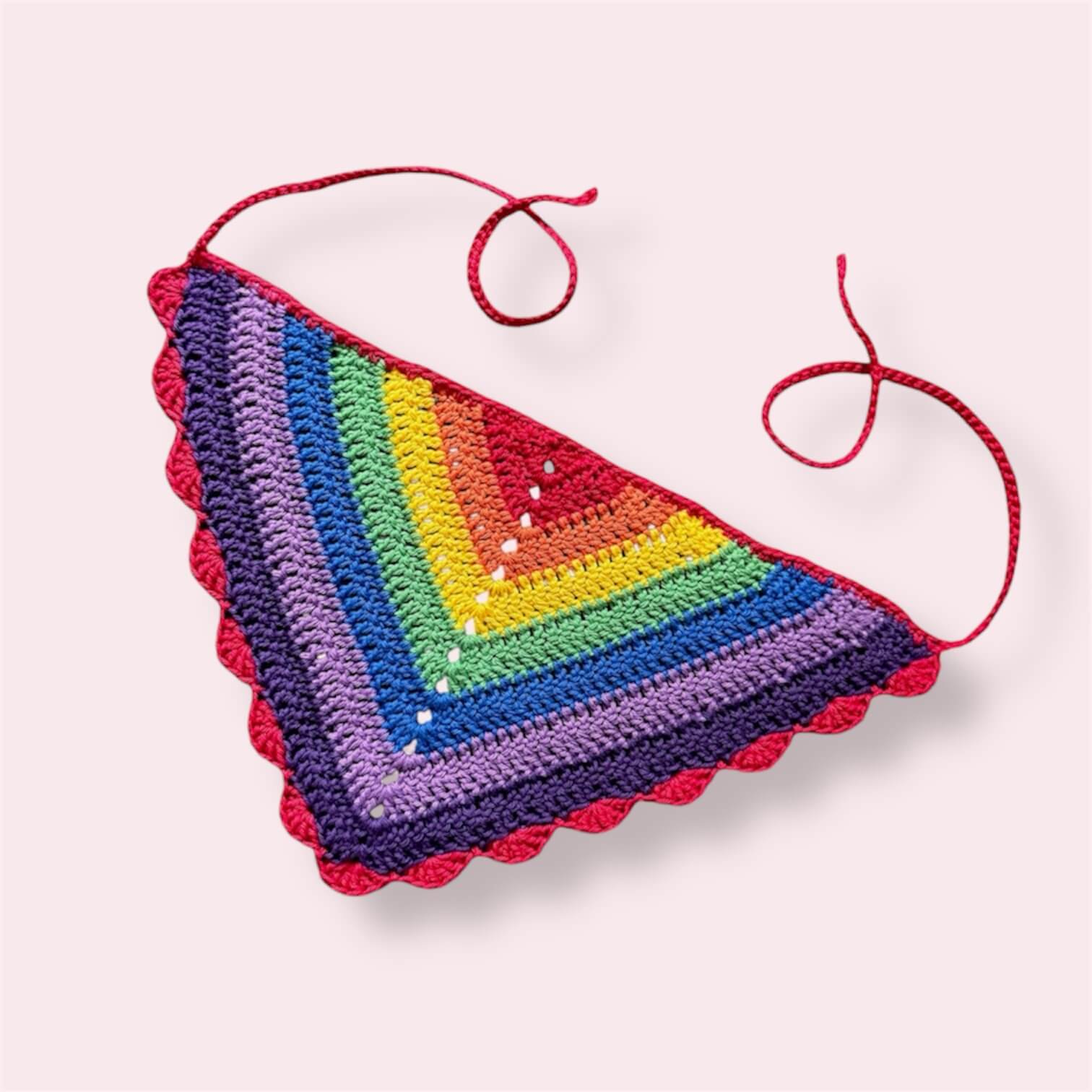 Crochet bandana in rainbow pride colors on plain background