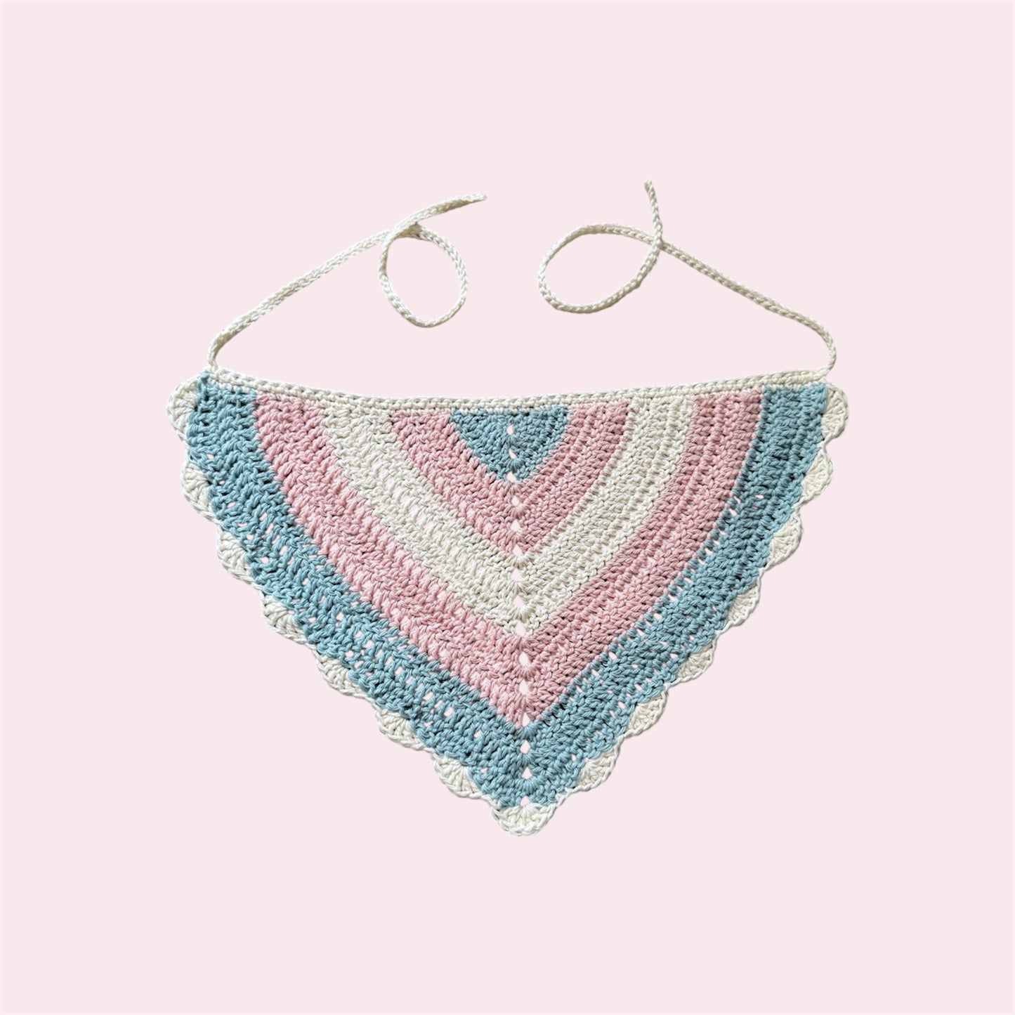 Crochet bandana in trans pride colors on a pink background