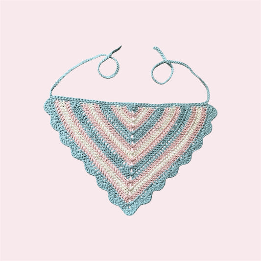 Crochet bandana in trans pride colors on a pink bakground