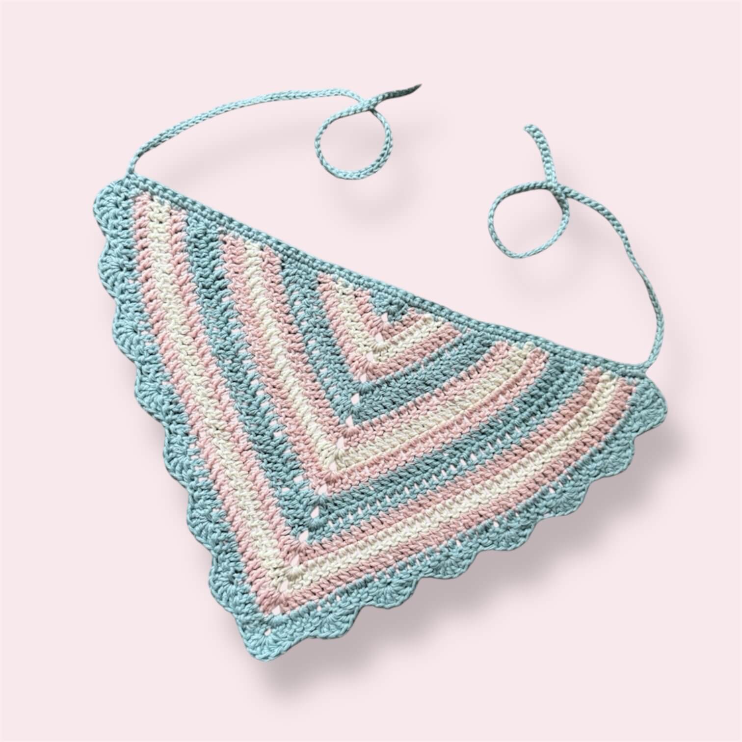 Crochet bandana in trans pride colors on plain background