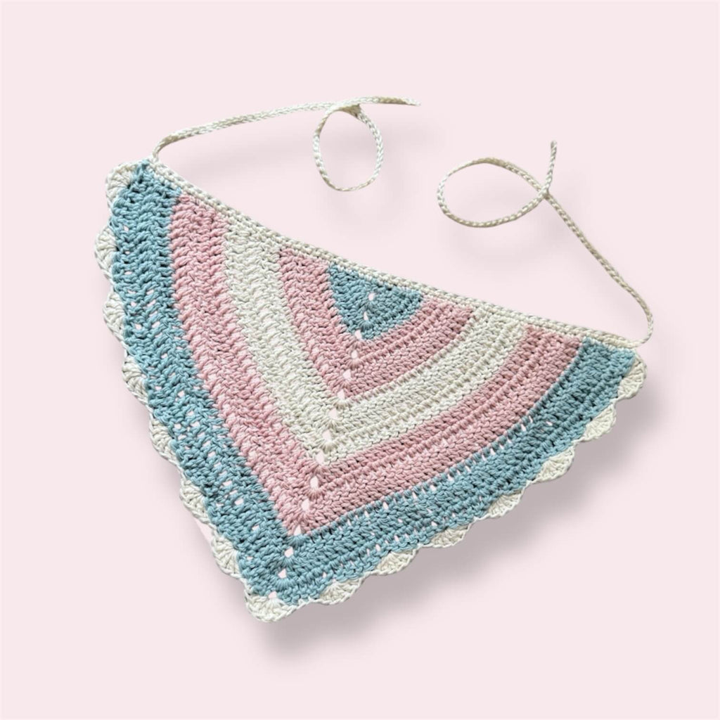 Crochet bandana in trans pride colors on plain background