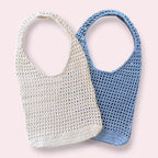 Crochet mesh tote bags on plain background