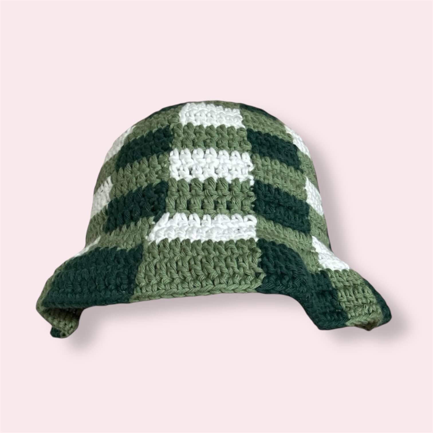 Crocheted green gingham bucket hat on plain background