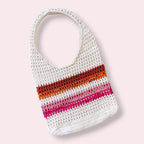 Crocheted lesbian mesh tote bag with white, orange, and pink stripes on a light pink background