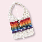 Crocheted mesh tote bag with rainbow stripes with measurements on a light pink background