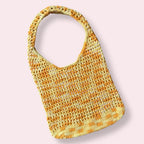 Crocheted yellow multicolor bag on a plain background