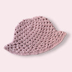 Dusty pink crochet bucket hat on plain background