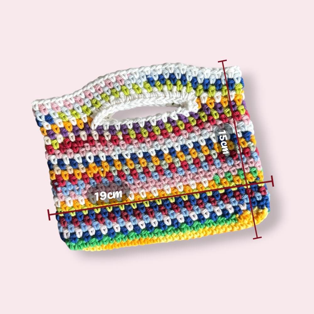 Flatlay of multicolor crochet purse with measurements