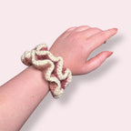 Frilly crochet scrunchies modeled on wrist