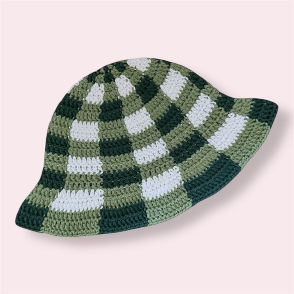 Green gingham crochet bucket hat on plain background