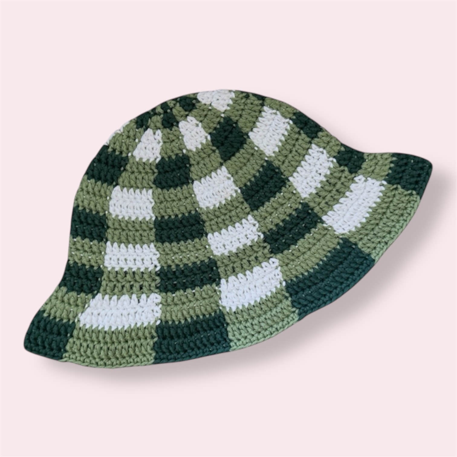 Green gingham crochet bucket hat on plain background