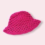 Hot pink crochet bucket hat on plain background