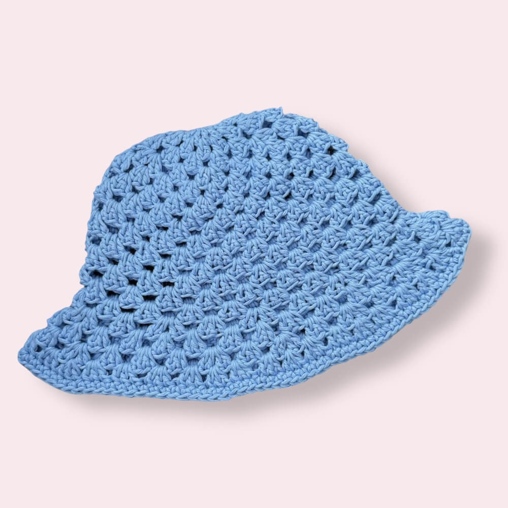 Light blue crochet bucket hat on plain background