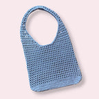 Light blue crochet mesh tote bag on plain background