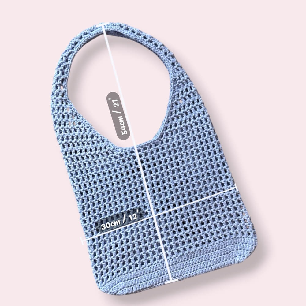 Light blue crochet mesh tote bag with measurements on plain background