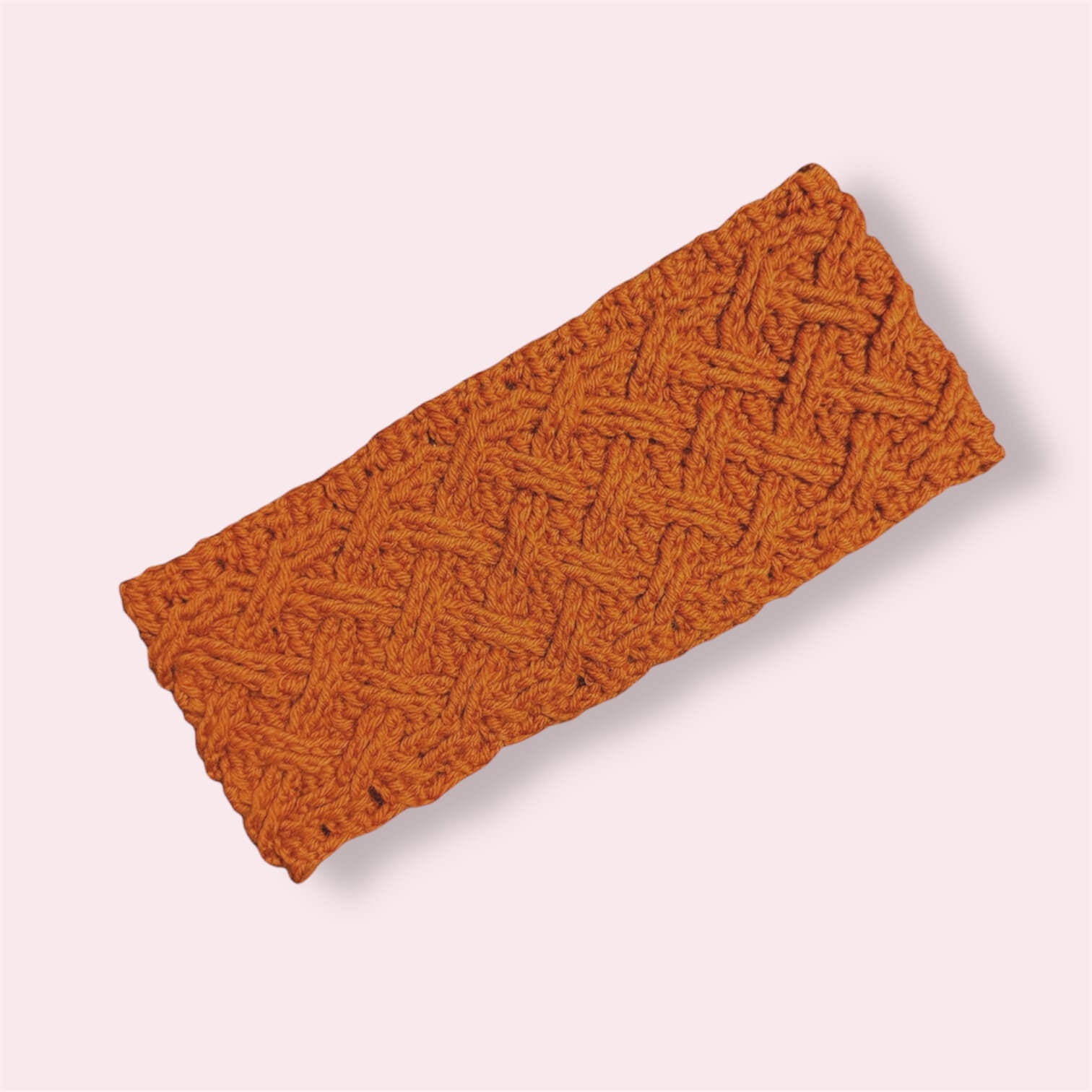 Orange wool earwarmer on plain background