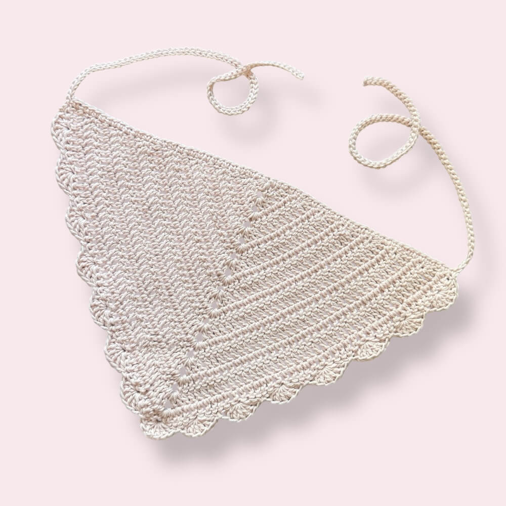 Pastel pink crochet bandana on plain background