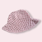 Pastel pink crochet bucket hat on plain background