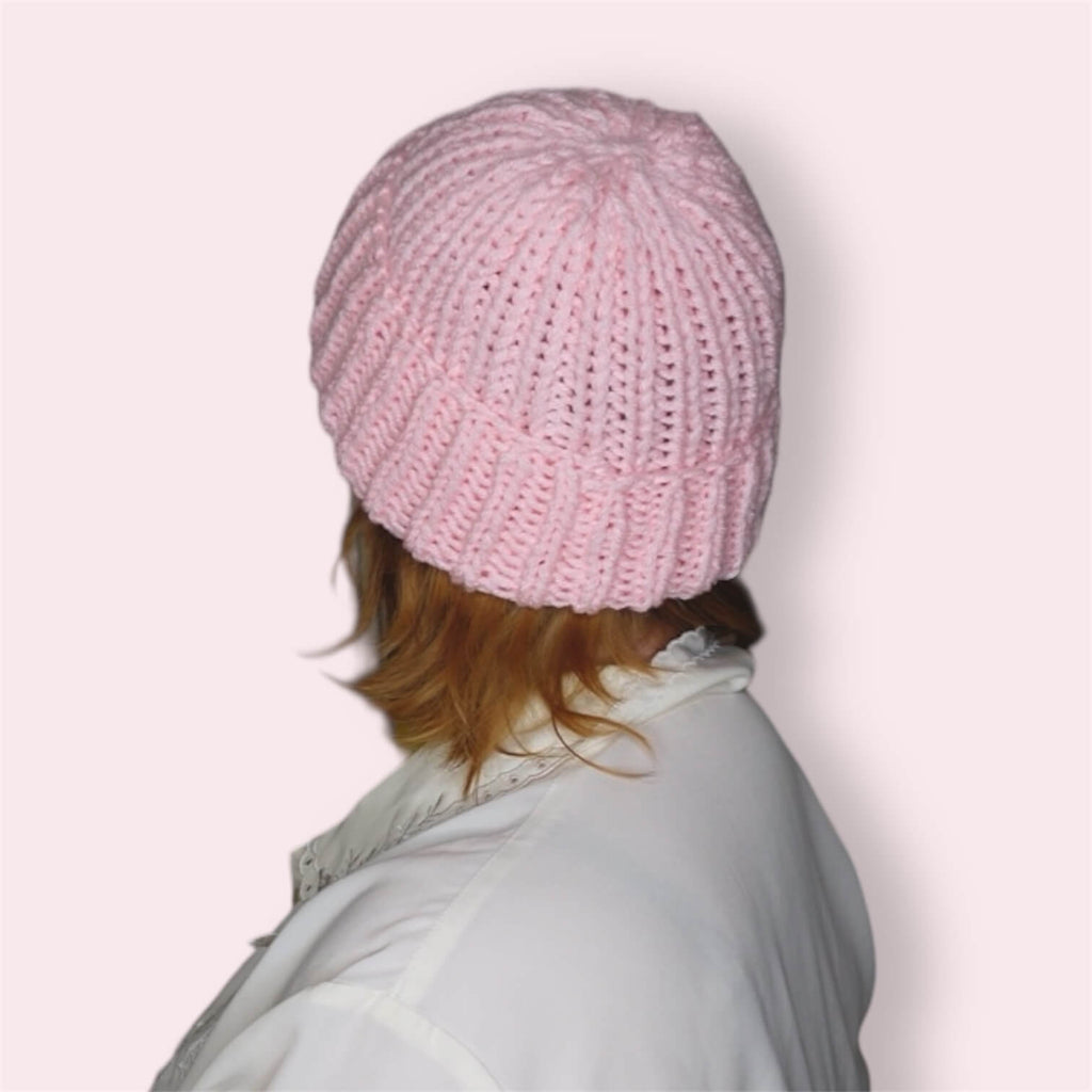 Person wearing pink knit beanie back view