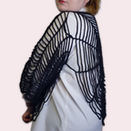 Person wearing a blackspiderweb shirt from the side on a plain background