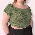Person wearing a green crochet top against plain background
